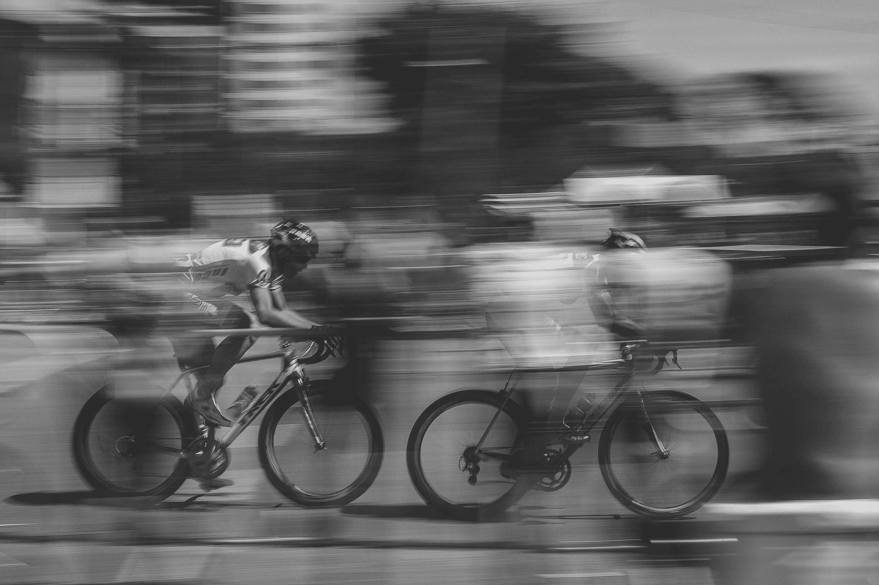 Cyclists moving through the city, panned in motion