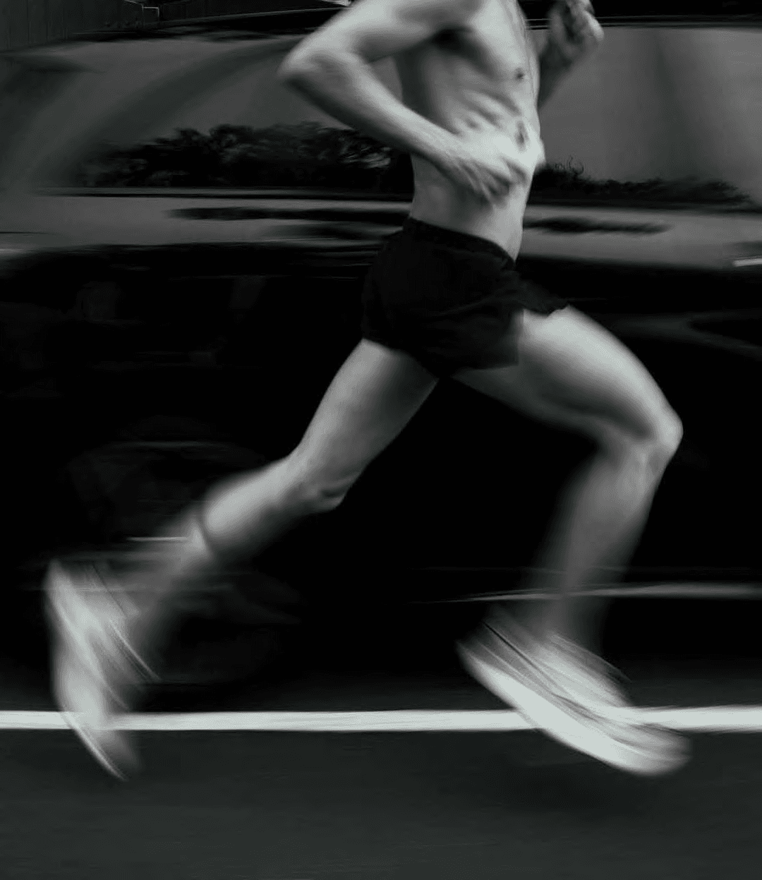A runner at full stride, watch banded at the wrist
